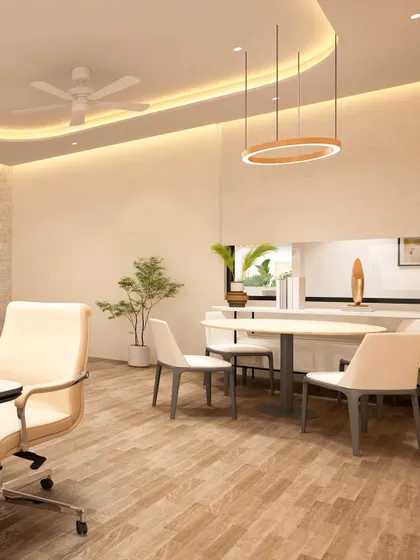 Another view of the Principal's Room at The Shri Ram Universal School, showing the informal meeting area. The space is designed to be flexible, allowing for both focused work at the desk and collaborative discussions at the round table.