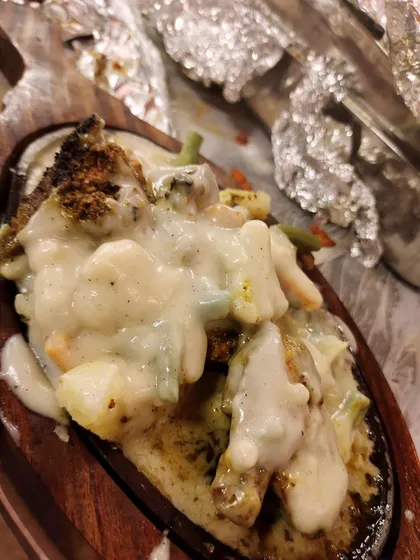 Our chicken sizzler is a complete dish in itself. Tender chicken and vegetables are served on a hot plate and topped with a creamy white sauce that sizzles as it arrives at the table.