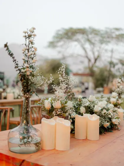 A close-up of the elegant table decor, featuring white flowers and candles. We believe in capturing the small details that contribute to the overall beauty and atmosphere of the wedding.