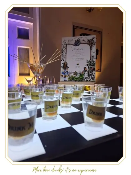 "Drink Me" shots arranged on a chessboard for our Wonderland-themed bar. This showcases our creativity in designing interactive and thematic drink experiences.