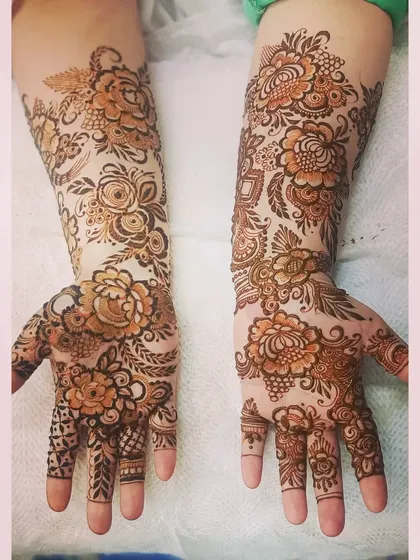 A full-arm floral design with soft shading, giving the peonies and roses a realistic, delicate appearance.