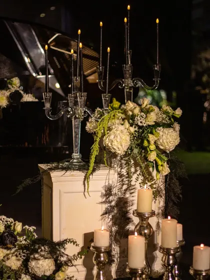 Another view of the piano-side arrangement, highlighting the delicate balance between the structured candelabra and the organic flow of the flowers. This is floral sculpture at its finest.