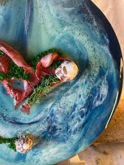 The way light hits the layers of resin creates a beautiful sense of depth, like looking into real water. This piece captures the movement of waves around a tiny, heart-shaped island.