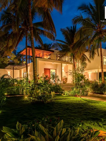 Imagine your guests unwinding here. This is a luxury villa we designed, illuminated at twilight to highlight its architectural beauty and integration with the lush landscape. We focus on creating photogenic spaces that attract bookings and create unforgettable stays.