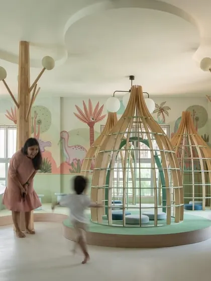 A candid moment of play and discovery in the nursery library. The design encourages interaction and movement, proving that a library can be a place of quiet contemplation and joyful energy.