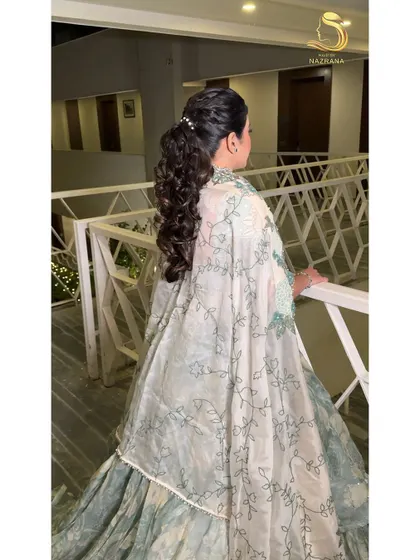 This angle shows the beautiful silhouette of the textured ponytail, perfect for a bride-to-be at her pre-wedding event.