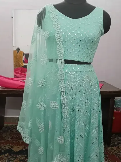 This mint green lehenga with mirror work is a fantastic choice for a Mehendi ceremony. The sleeveless blouse and light, airy skirt are both comfortable and stylish.