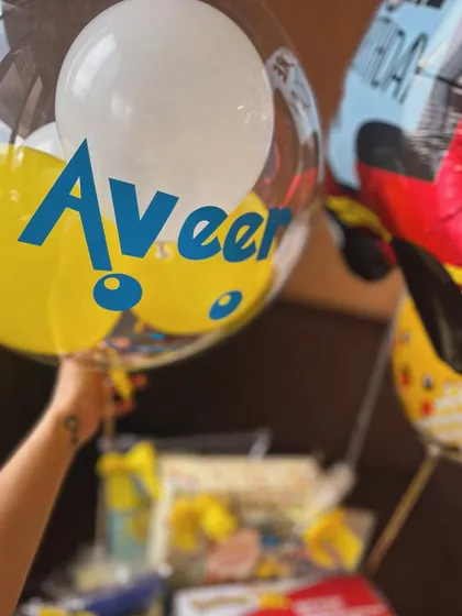 The personalized balloon with the name "Aveer" adds a festive and custom touch to the large Pokémon-themed birthday gift basket.