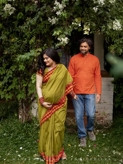 A candid walking shot of the couple through a garden path. These relaxed, in-motion photos capture the easy and joyful connection between partners as they look forward to their new beginning.