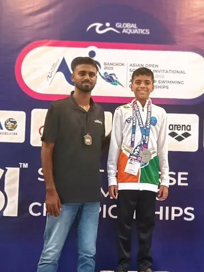 The podium is where hard work pays off. Bryce and his coach pose for a photo at the AOSI Short Course Championships in Bangkok. This moment captures the pride and accomplishment of competing and winning on an international stage.