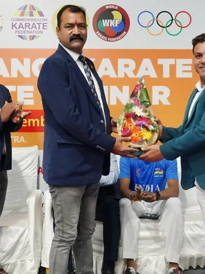 A formal moment of exchange at the inauguration of the Pune Kumite seminar. We collaborate with various state associations and officials to ensure our training programs have a wide reach.