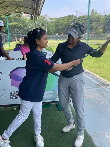 Here I am showing a student how the club should feel at the top of the backswing. This tactile feedback is essential for building a repeatable motion.