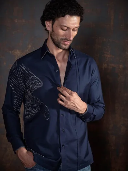 Elevate your wardrobe with this exquisite bird embroidered shirt. The detailed stitching on the navy fabric makes it a standout piece for any occasion.