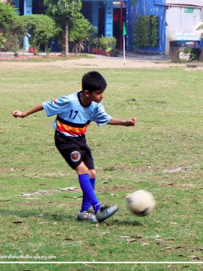A player takes a powerful shot on goal. I train my players to be confident and decisive in front of the goal, turning practice into match-winning performance.