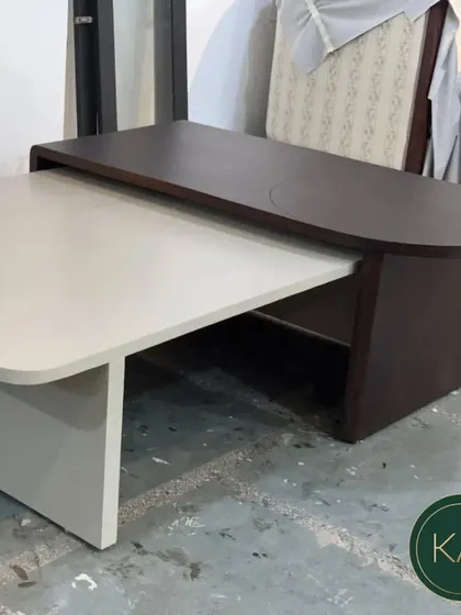 The two-tone nesting coffee table shown in our workshop, highlighting its unique shape and solid construction.