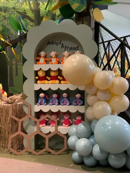 An "Adopt a Friend" station where each child could take home their own plush character from the Hundred Acre Wood.
