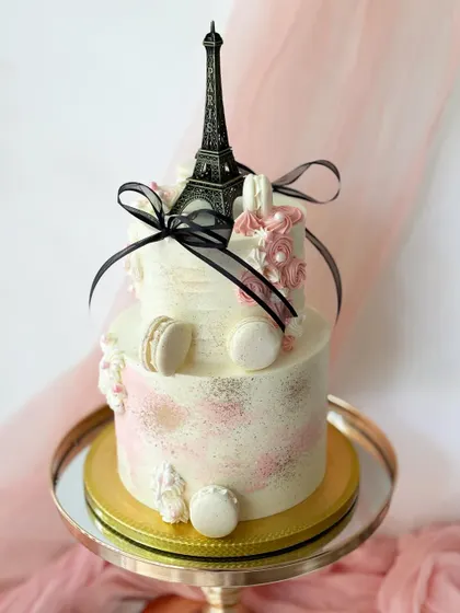 Another view of the Paris-themed cake, highlighting the abstract buttercream texture and gold-dusted details.