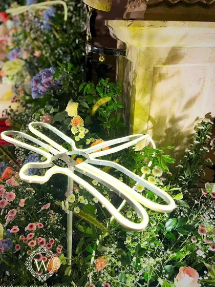 For this whimsical garden reception, we used glowing LED dragonflies and birds nestled among pastel floral arrangements. These unique lighting elements added a touch of magic and sophistication to the decor.
