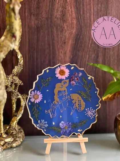 Bring divine love into your home with a custom Radha Krishna frame. This piece, set against a deep blue background and adorned with real flowers, is perfect for your altar or as a thoughtful gift.