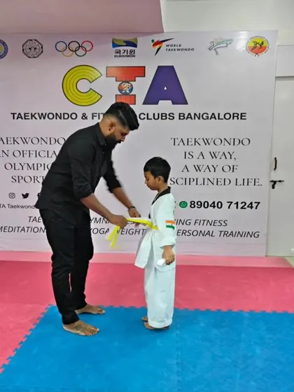 Tying a yellow belt.