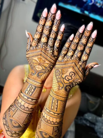 A full-coverage back-hand design with a mix of floral and geometric patterns. The intricate details and the beautiful manicure create a stunning overall look.
