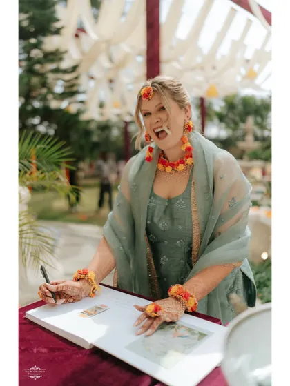 Capturing the laughter and joy of guests is just as important. Here, a guest shares a happy moment while signing the wedding guestbook.