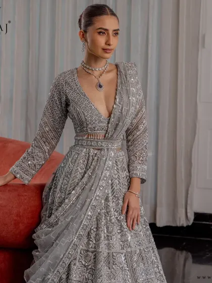A closer look at the silver lehenga, highlighting its plunging neckline and structured blouse that bring a bold, contemporary twist to a timeless silhouette.