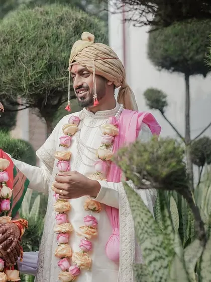 A quiet moment together amidst lush greenery. This portrait of our Maharashtrian couple showcases their traditional attire and the gentle connection they share after the ceremony.