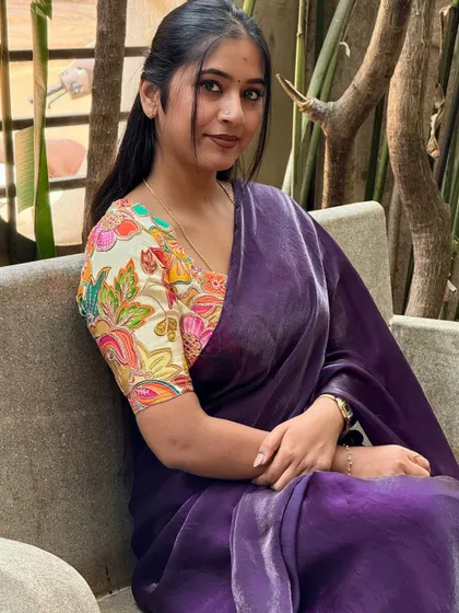Another portrait from this serene garden shoot. The focus here is on the beautiful printed blouse that adds so much life to the plain saree. It's a perfect example of a chic, modern saree look.