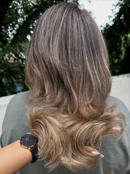 A beautiful ash blonde look with a soft, layered cut. This is a great example of a cool-toned color that looks modern and chic.