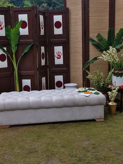 A simple and meaningful photo corner for a spiritual event. I used a traditional wooden screen with auspicious handprints, fresh banana plants, and white floral arrangements to create a spot that is both beautiful and culturally significant.
