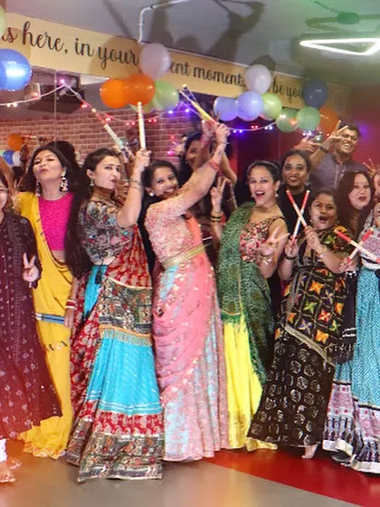 The whole group celebrating together with their dandiya sticks. This image perfectly captures the festive, high-energy vibe of my Garba nights.