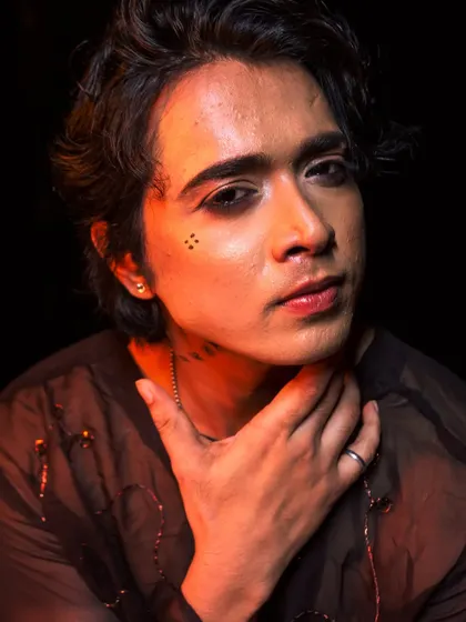 A close-up of the creative male makeup, featuring subtle graphic details and perfectly groomed brows.