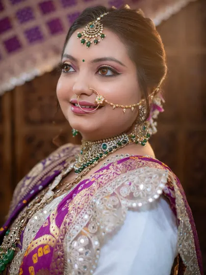 A beautiful portrait of a bride in her traditional Gujarati attire, looking elegant and serene.