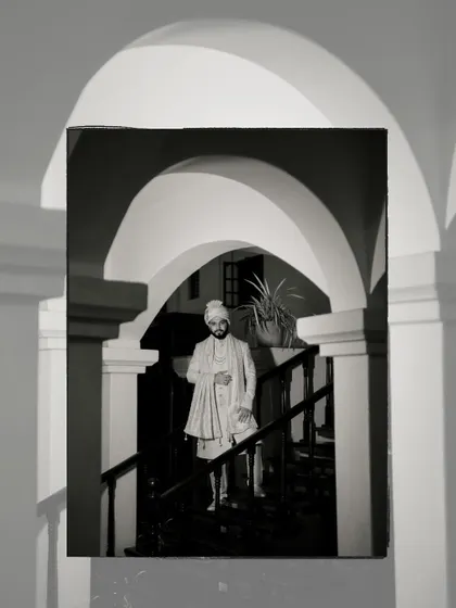 A dramatic black and white portrait of the groom, using architectural arches and shadows to create a powerful and artistic image.