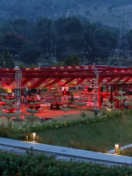 A wide view of a reception designed to impress. The entire venue, set against the mountains, was transformed with dramatic red lighting and a signature windmill feature, creating a truly magical destination wedding experience.