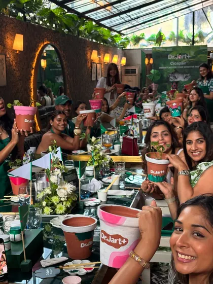 The whole group from the Dr. Jart+ event holding up their personalized pots. The energy was amazing, and everyone left with a plant and a piece of their own art.