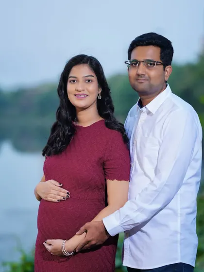 A portrait of an expecting couple by the water. The natural landscape provides a peaceful and scenic backdrop for their maternity photos.