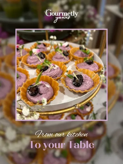 Delicate purple-hued tarts topped with blueberries and microgreens. This visually stunning appetizer showcases our creative use of color and flavor.