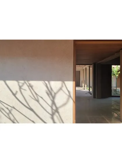 The shadow of a tree falls on the lime and sand plaster wall in Alibaug. We love how natural materials interact with their environment throughout the day.