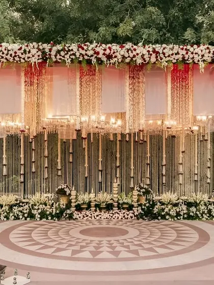 The sacred space where forever begins. We design breathtaking mandaps like this one, featuring a canopy of cascading florals and elegant lighting to create a truly divine atmosphere for your wedding ceremony.