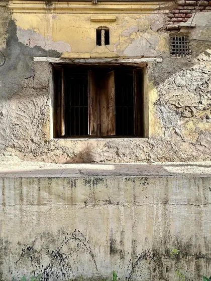 A weathered wall and window at Majumdar Wada. The textures of peeling plaster, exposed brick, and aged wood tell a story of time and use. These are the surfaces that I believe hold the memory of a place.
