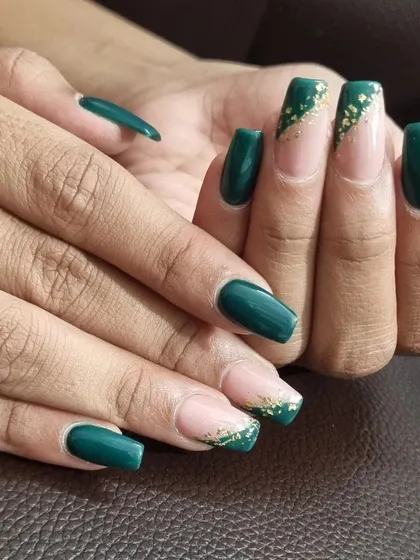 A close-up of the deep green and gold foil French manicure. We carefully placed each foil piece to create a beautiful, sparkling gradient effect.