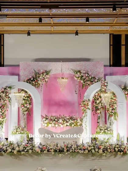 A full view of the pastel pink and white reception stage, showcasing the balanced and symmetrical design.