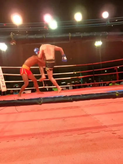 A powerful knee strike from the clinch, demonstrating the effectiveness of our Muay Thai training in a competitive setting.