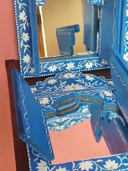A close-up of the Jharokha mirrors, showing the reflection and the fine details of the paintwork.
