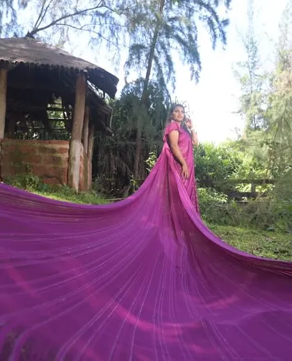 This long, flowing purple saree is a unique option for a maternity or pre-wedding shoot. The extra-long trail adds a dramatic flair to a traditional outfit.