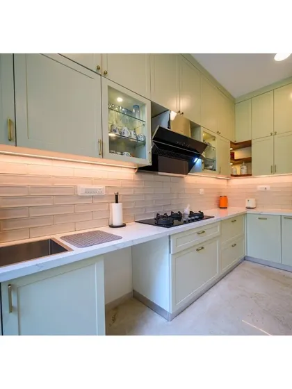 Inspired by the American Ranch style, this kitchen embraces the warmth of natural materials with its soft green cabinets, subway tile backsplash, and modern amenities.