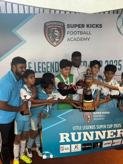 The complete U12 team celebrating their runners-up trophy. It's a collective achievement that includes every player, coach, and supporting parent.