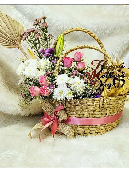 A full view of my fresh floral and gourmet basket for Mother's Day. The combination of beautiful blooms and delicious treats makes it a gift any mom would love.
